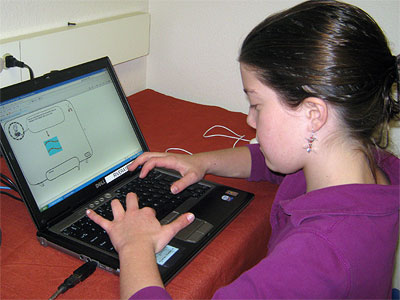 A youngster plays computer game in Susan Rivera’s UC Davis lab.